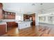 Modern kitchen with hardwood floors, kitchen island, and stainless steel appliances at 1009 Ancient Timber Ave, Henderson, NV 89052