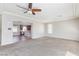 Spacious living room with neutral carpet and open view into the kitchen at 1009 Ancient Timber Ave, Henderson, NV 89052