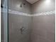 Modern shower featuring gray tile, mosaic accents, and a sleek shower head at 1009 Ancient Timber Ave, Henderson, NV 89052