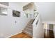Carpeted staircase with white railings and a large transom window at 1009 Ancient Timber Ave, Henderson, NV 89052