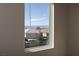 A window showcases a lovely neighborhood and mountains in the distance from inside the house at 1009 Ancient Timber Ave, Henderson, NV 89052