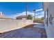 Enclosed backyard with a brick patio, concrete slab, and block wall offering privacy at 10216 Via Roma Pl, Las Vegas, NV 89144