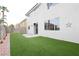 Generous backyard area offers artificial grass, a small patio, block walls and potential for entertaining at 10216 Via Roma Pl, Las Vegas, NV 89144