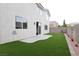 Spacious backyard features low-maintenance turf, stucco walls, and a concrete patio for outdoor enjoyment at 10216 Via Roma Pl, Las Vegas, NV 89144