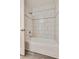 Tiled bathtub and shower combination with silver trim and hardware, and open door at 10216 Via Roma Pl, Las Vegas, NV 89144