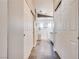 Hallway view leading to a bathroom with a glass shower, double sinks, and plenty of counter space at 10216 Via Roma Pl, Las Vegas, NV 89144