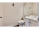Bathroom with white sink, toilet and vanity at 10216 Via Roma Pl, Las Vegas, NV 89144