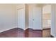 Bedroom with wood flooring, closet, and access to the hallway at 10216 Via Roma Pl, Las Vegas, NV 89144