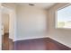 Well-lit bedroom featuring wood floors, a window, and neutral wall colors at 10216 Via Roma Pl, Las Vegas, NV 89144