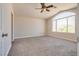 Bedroom featuring a ceiling fan and a large window allowing ample natural light at 10216 Via Roma Pl, Las Vegas, NV 89144