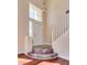 Foyer with wood floors, chandelier, and staircase leading to the upper level at 10216 Via Roma Pl, Las Vegas, NV 89144