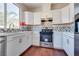 Bright kitchen features stainless steel appliances, white cabinets, and stylish backsplash at 10216 Via Roma Pl, Las Vegas, NV 89144