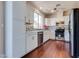 Modern kitchen features stainless steel appliances, white cabinets, and stylish backsplash at 10216 Via Roma Pl, Las Vegas, NV 89144