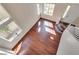 Sunlit living room showcasing gleaming wood floors and a stylish chandelier at 10216 Via Roma Pl, Las Vegas, NV 89144