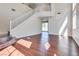 Bright living room features hardwood floors, staircase, and chandelier with high ceilings at 10216 Via Roma Pl, Las Vegas, NV 89144