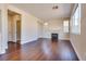 Spacious living room featuring a cozy fireplace, neutral paint, and hardwood flooring at 10216 Via Roma Pl, Las Vegas, NV 89144