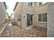 A cozy backyard patio has paver stones, a sliding glass door, and access to the AC unit at 11023 Mount George St, Las Vegas, NV 89179