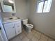 Well-lit bathroom featuring a modern vanity, toilet, and window, tiled flooring at 1132 S 10Th St, Las Vegas, NV 89104
