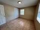 Comfortable bedroom featuring tile flooring, a closet, and a window at 1132 S 10Th St, Las Vegas, NV 89104