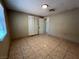 Neutral bedroom with tile flooring and a closet, bathed in natural light at 1132 S 10Th St, Las Vegas, NV 89104
