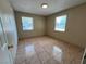 Well-lit bedroom with tile flooring, two windows, and a closet at 1132 S 10Th St, Las Vegas, NV 89104