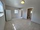 Bright kitchen area with tile flooring and a white refrigerator; adjacent to a bathroom at 1132 S 10Th St, Las Vegas, NV 89104