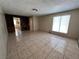 Open living room featuring tile flooring, built-in shelving, and bright windows at 1132 S 10Th St, Las Vegas, NV 89104