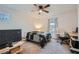 Bedroom with a ceiling fan, a bed with a dark quilt, a desk, and a TV at 1328 Graphite Ave, Henderson, NV 89002