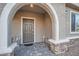 Inviting covered entry features a stone base, neutral paint, and a stylish front door at 1328 Graphite Ave, Henderson, NV 89002