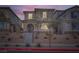 Charming two-story home with a landscaped yard, arched entry, and appealing curb appeal at twilight at 1328 Graphite Ave, Henderson, NV 89002
