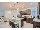 Well-lit kitchen with stainless steel appliances, dark cabinets, and modern finishes at 1328 Graphite Ave, Henderson, NV 89002