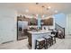 Modern kitchen features stainless steel appliances, granite countertops, and pendant lighting at 1328 Graphite Ave, Henderson, NV 89002