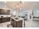 Open kitchen featuring an island with sink, pendant lighting, and adjacent dining area at 1328 Graphite Ave, Henderson, NV 89002
