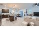 Open-concept living room flows seamlessly into a kitchen and dining area with sleek, modern finishes at 1328 Graphite Ave, Henderson, NV 89002