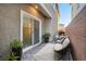 Private patio with modern furniture, planters, and a sliding glass door at 1328 Graphite Ave, Henderson, NV 89002