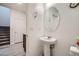 Powder room featuring a pedestal sink, modern fixtures, and sleek design at 1328 Graphite Ave, Henderson, NV 89002