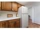 Kitchen showcases oak cabinetry and adjacent white refrigerator at 1340 N Jones Blvd, Las Vegas, NV 89108