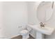 A bright bathroom featuring a pedestal sink and toilet at 1785 Flycatch St, Las Vegas, NV 89138