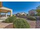 Backyard with desert landscaping and covered patio at 2088 Sawtooth Mountain Dr, Henderson, NV 89044