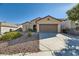 Single-story home features a two-car garage and desert landscaping at 2088 Sawtooth Mountain Dr, Henderson, NV 89044