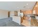 Kitchen features granite countertops, wooden cabinets, and bar seating at 2088 Sawtooth Mountain Dr, Henderson, NV 89044