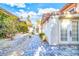 Beautiful backyard with stone pavers, lush greenery, and a view of the home's exterior at 2204 Plaza De La Candela, Las Vegas, NV 89102