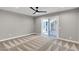 Bright bedroom with fan, neutral paint, and sliding glass door to patio at 2204 Plaza De La Candela, Las Vegas, NV 89102