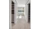 Hallway looking into a bathroom and featuring neutral walls and modern gray tile at 2204 Plaza De La Candela, Las Vegas, NV 89102