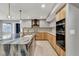 Modern kitchen features a waterfall island, stainless steel appliances, and sleek cabinetry at 2204 Plaza De La Candela, Las Vegas, NV 89102