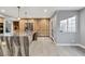 Open kitchen with stone countertops, modern wood cabinetry, stainless steel appliances, and natural light at 2204 Plaza De La Candela, Las Vegas, NV 89102