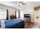 Cozy bedroom with a ceiling fan, wood floors, and a view into the hallway at 2673 Red Rock St # 102, Las Vegas, NV 89146