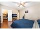 Comfortable bedroom with wood floors, ceiling fan, walk-in closet, and TV at 2673 Red Rock St # 102, Las Vegas, NV 89146