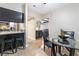 Open dining area connects to the kitchen, featuring a glass table and bar seating at the kitchen counter at 2673 Red Rock St # 102, Las Vegas, NV 89146