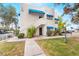 Charming two-story exterior with blue awnings, grassy lawn, walkway, and stairs at 2673 Red Rock St # 102, Las Vegas, NV 89146